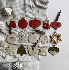 various ornaments are laid out on a white tablecloth and placed next to each other