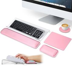 a computer keyboard, mouse and other accessories on a desk with a pink cover over it