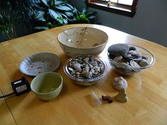 a wooden table topped with bowls filled with rocks