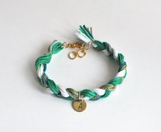 This personalized bracelet can be a lovely gift to your friends and family or even to yourself. Emerald green braid bracelet has hand stamped initial charm that hangs from the middle. Braid is made from green, teal and white cotton yarn and satin ribbon. It also has delicate gold plated chain. Bracelet closes at the back and is very comfortable to wear.Please choose initial from drop down menu.Check other items in my shop http://www.etsy.com/shop/LeiniJewelry >>>Materials used:-  cotton yarn, sa Cheap Green Adjustable Friendship Bracelets, Bracelet Yarn, Green Friendship Bracelet, Bracelet Emerald, Braid Bracelet, Diy Best Friend Gifts, Cotton Bracelet, Knit Bracelet, Medical Bracelet