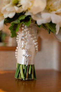 the bride's bouquet is adorned with pearls