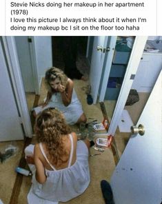 two women sitting on the floor in front of a mirror