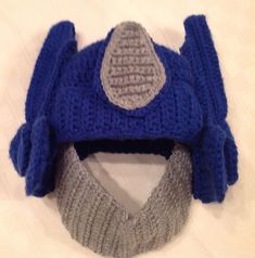 a knitted blue hat with grey and white details