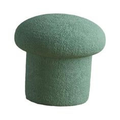 a green stool that is shaped like a round footstool on a white background