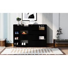 a living room with a rug and black cabinet