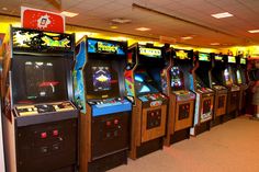 several arcade machines lined up in a room