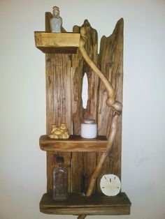 a shelf made out of wood with some items on it and a clock next to it