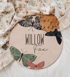 a wooden sign that says willow fox with butterflies on it