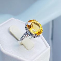 Natural Yellow Citrine Ring  Edward Design#70z (10x12 version) Custom/Made to Order Here we have an Edwardian reproduction ring in sterling silver filigree with a lovely Natural genuine 3.3ct Yellow Citrine gemstone solitaire. This full cut oval gem is 12mm in length and 10mm in width. This ring also sits 7mm off the finger. The inside of the band is marked 925 for sterling silver. Notice the beautiful leaf design of the silver filigree setting and etched band. This is a lovely rendition of an A Yellow Oval Birthstone Ring, Yellow Oval Topaz Ring With Center Stone, Yellow Oval Topaz Ring With Accent Stones, Oval Yellow Topaz Ring With Accent Stones, Oval Topaz Gemstone With Center Stone, Yellow Oval Topaz Rings, Classic Yellow Oval Topaz Ring, Oval Topaz Gemstones With Prong Setting, Yellow Oval Topaz Ring Hallmarked