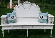 a white bench with two pillows on it