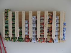 a wooden pallet filled with soda cans on top of a white table next to a red and white striped flag