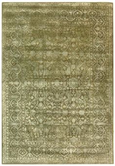 a green rug with an intricate design on the top and bottom, it is made from wool