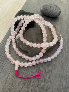 This rose quartz mala necklace has a light pink tone that will be easy to match your everyday outfits and keep you calm and grounded if you use it while meditating. Its a unique decor item also. A perfect gift for a yoga lover, or someone that loves stones. You can use it as a necklace or wrap it around the wrist and becomes a bracelet. The Mala necklace has a drop length of 43cm- 17 inch. A most have addition to your jewelry collection. ⚡️Join Akashi's VIP list for early bird discount access⚡️ Tibetan Mala, Rose Quartz Mala, Buddhist Bracelet, Buddhist Mala, Wiccan Necklace, Yoga Lover Gift, Karma Necklace, 108 Mala Beads, Rose A