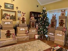 a christmas tree is decorated with gingerbreads and presents in front of the window