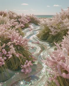 pink flowers are growing on the side of a stream in front of some grass and water