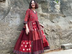 Red dress in an easy to wear Madame Hall design from hand printed, 100% cotton. It blends an international vibe with the Indian charm of superb Ajrakh block prints! The art wear vibe is unmistakable in a pattern mix of stunning fabrics, all  printed by hand with natural dyes. This dress will satisfy women who love artistry, and love India's hand handmade textiles.  It combines Ajrakh prints by one of Indias's celebrated textile artists in a Madame Hall design that'll adapt to the seasons. It'll  look just as great layered worn with boots, as it does on a sunny summer's day. I've designed this dress with a simple V neck bodice, and let loose pattern magic in the full tiered skirt. The pattern contrasts of gorgeous florals, polka dots and abstract are all stunning prints. They create magic i Red Bohemian Dress With Kalamkari Print, Bohemian Red Dress With Kalamkari Print, Traditional Red Block Print Maxi Dress, Red Cotton Dresses With Printed Motifs, Traditional Red Maxi Dress With Block Print, Red Cotton Dress With Bandhani Print, Festive Red Cotton Dress, Red Cotton Batik Print Dresses, Red Block Print Maxi Kurta