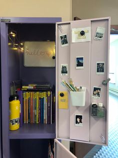 a purple book case with books and pictures on the front is open to show what's inside