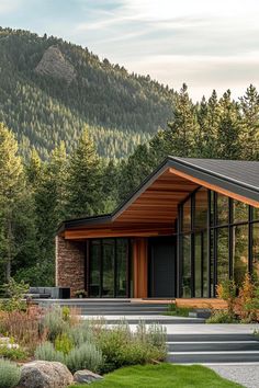 a modern house in the mountains surrounded by greenery