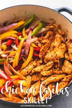 chicken fajitas skillet with peppers, onions and bell peppers in a pan