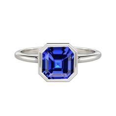 Bezel Set Asscher Sapphire Ring For Women METAL SPECIFICATIONS White Gold 14K STONE SPECIFICATIONS Stone Name : Blue Sapphire Stone Cut : Asscher Stone Details : There is one asscher cut sapphire approx. 2 carats (Approx. Size 8 x 6 mm) in the ring. Natural earth mined stone. Quality of Sapphire : AAA Total : Approx. 2 Carats RING SPECIFICATIONS Size : 6.5 (Can ship in any size, please send us a message about size after placing the order) Appraised Value : $6,498.00 Comes with Certificate Laos Jewelry, 2 Carat Ring, Blue Sapphire Stone, Sapphire Solitaire Ring, White Gold Solitaire, Gold Solitaire Ring, Sapphire Solitaire, Sapphire Engagement Ring Blue, Asscher Cut