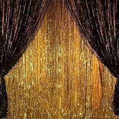 an open curtain with gold sequins and curtains on the wall in front of it