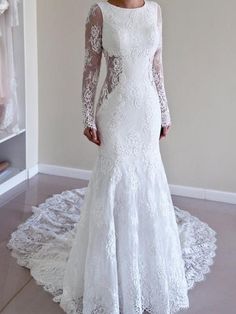 a woman in a white wedding dress standing on a rug