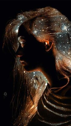 a woman with long hair and stars on her head is shown in this artistic photo