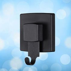 a black square light switch on a blue background