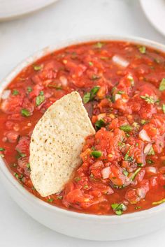 a white bowl filled with salsa and tortilla chips