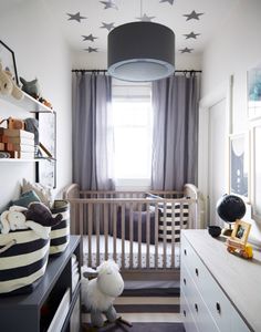 a baby's room with stars on the ceiling