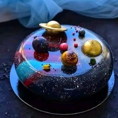 a cake with planets on it sitting on a table