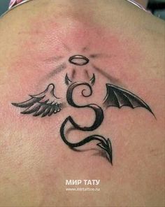 the back of a woman's neck with an angel and snake tattoo on it