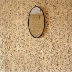 an oval mirror hanging on the wall