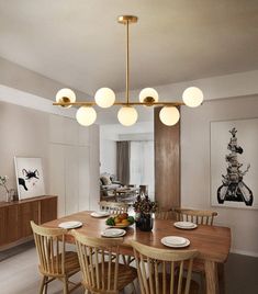 a dining room table with plates and bowls on it