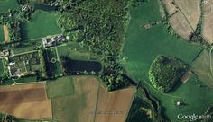 an aerial view of the countryside with lots of green grass and trees, including fields