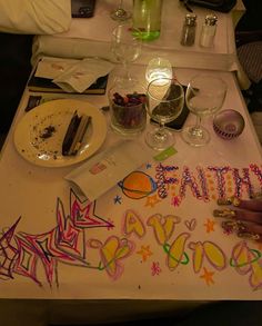 the table is covered with birthday decorations and confetti