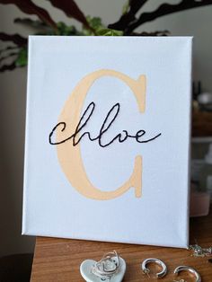 an acrylic sign with the word love written in cursive writing on it