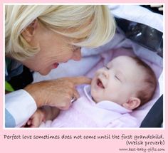 an older woman holding a baby in her lap and looking at it's face