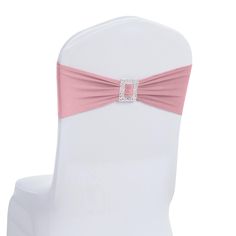 the back of a white chair with pink sash