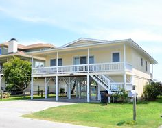 the house is white and has two balconies