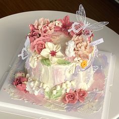 there is a cake decorated with flowers and butterflies