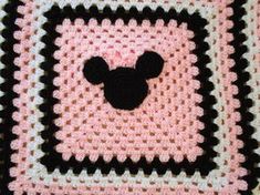 a crocheted square with a mickey mouse head on it's center piece