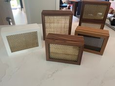 four wooden frames sitting on top of a counter