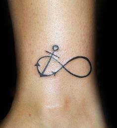 a small tattoo on the ankle of a woman's foot with an anchor in it