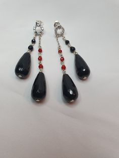 Fantastic earrings in 925% silver with black onyx, faceted teardrop cut: 20x10mm, electric black colour, faceted sphere cut: 4mm; Ball-cut carnelian: 3 mm; and small cubic zircons in the upper part covering the lobe. Perfectly balanced pin and butterfly closure, fit: 85x20 mm. Original, elegant, current, glamorous Black Faceted Teardrop Jewelry, Teardrop Stone Earrings For Party, Black Teardrop Gemstone Earrings, Black Teardrop Drop Earrings For Party, Black Drop Teardrop Earrings For Party, Black Teardrop Earrings For Party, Elegant Black Faceted Earrings, Black Drop Earrings For Formal Occasions, Formal Black Crystal Dangle Earrings