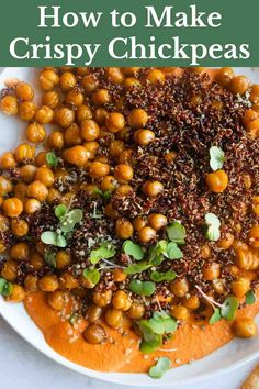 a white plate topped with chickpeas and sauce