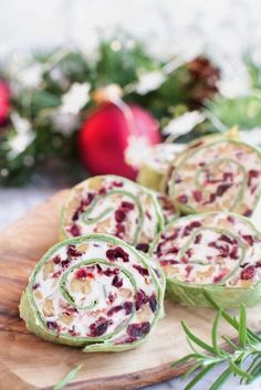 some food is sitting on a cutting board next to christmas greenery and baubles