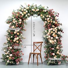 a chair sitting in front of a floral arch with measurements for the seat and back