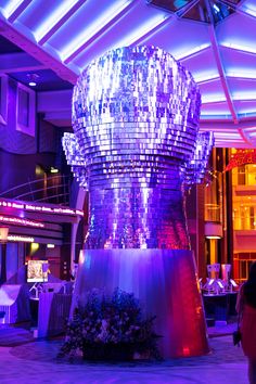 a giant ice bucket sitting in the middle of a room filled with tables and chairs