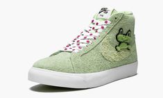 The Frog x Nike SB Blazer Mid is a special edition of the classic mid-top skate shoe in collaboration with Frog Skateboards.  The thoroughly unique look for the Blazer Mid features a brushed suede upper in light green with a chenille frog patch peeking out over each lateral Swoosh, while “frog” is found on each heel.  Ladybugs cover the laces, and a single ladybug appears on the rear of each midsole.  The playful look is on par with Frog’s aesthetic for their skate deck graphics and apparel.  Th Nike Sb Zoom Blazer Mid, Nike Sb Zoom Blazer, Nike Sb Blazer, Nike Sb Zoom, Cute Nike Shoes, Cute Nikes, Stadium Goods, Blazer Mid, Latest Sneakers